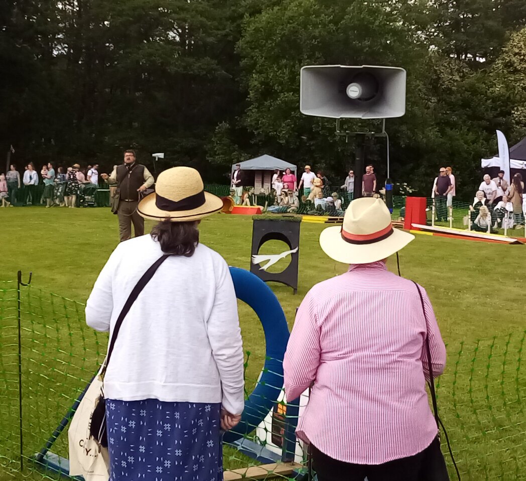 Weatherproof speakers on stands in an outdoor field